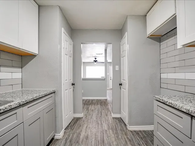 a view of a kitchen cabinets and wooden floor