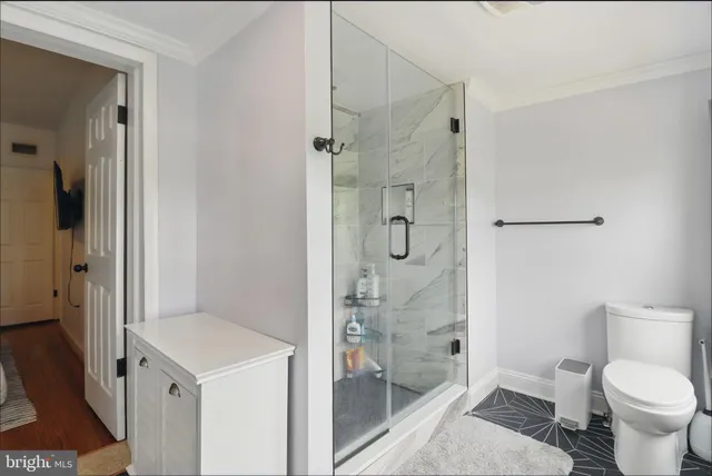 a bathroom with a shower toilet and sink