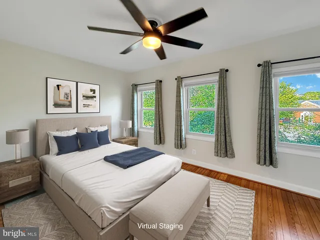 a bedroom with a large bed and a large window