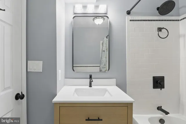 a bathroom with a sink a toilet and mirror