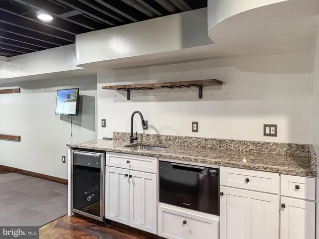 a kitchen with stainless steel appliances granite countertop a sink and cabinets