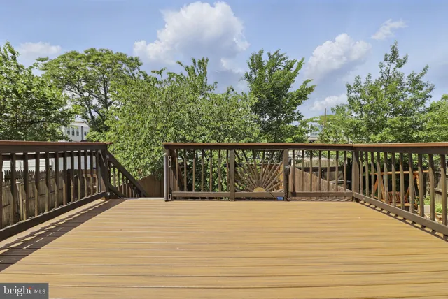 a view of balcony with wooden floor and fence