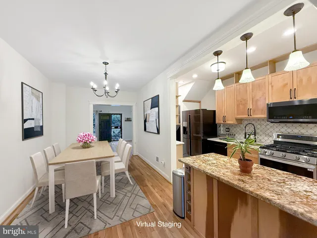 a large kitchen with a table and chairs