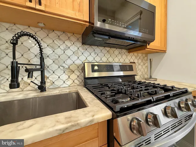 a stove top oven sitting inside of a kitchen