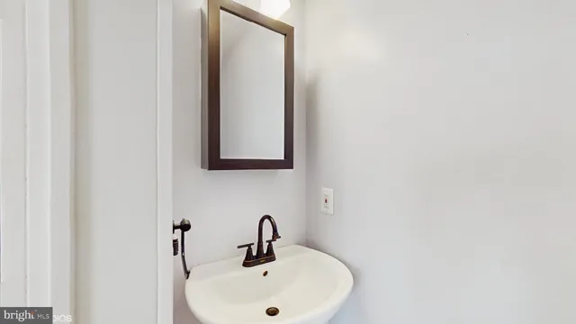 a bathroom with a sink and mirror
