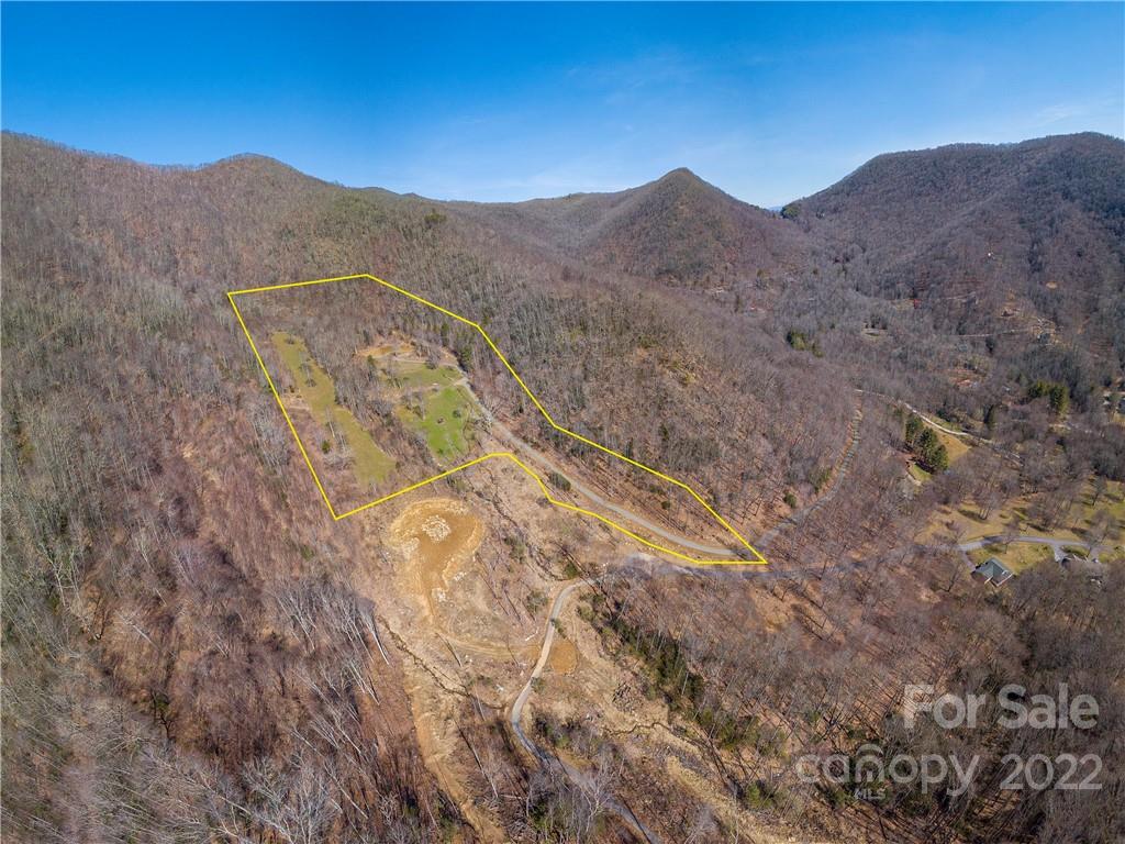 435 Seeley Cove Road Clyde, NC 28721 - Photo 17 of 17 a view of a dry yard with mountains in the background