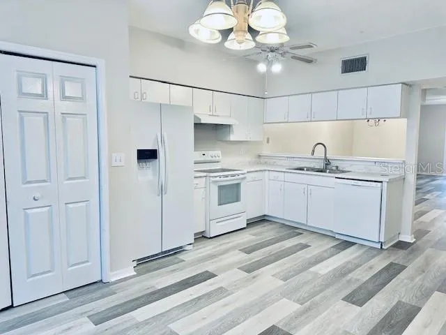 a kitchen with a sink cabinets and window