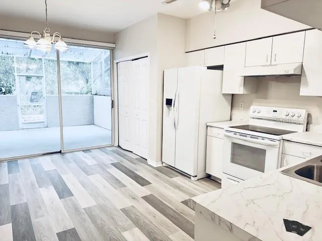 a kitchen with stainless steel appliances a stove a refrigerator and cabinets