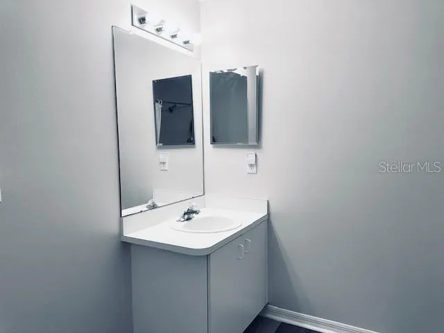 a bathroom with a sink and mirror