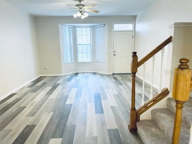 a view of an entryway with wooden floor