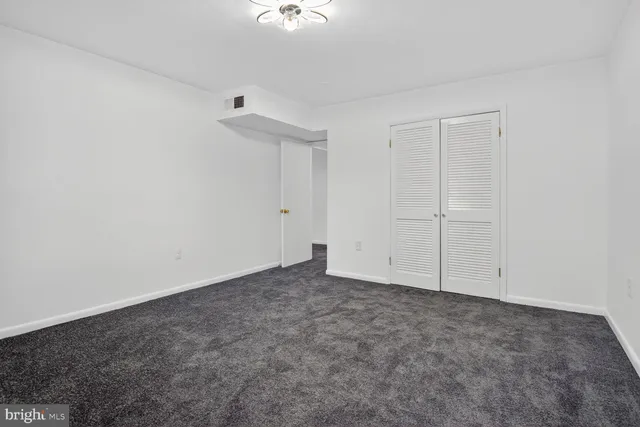 an empty room with a ceiling fan