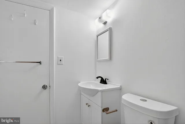 a white toilet sitting next to a bathroom sink