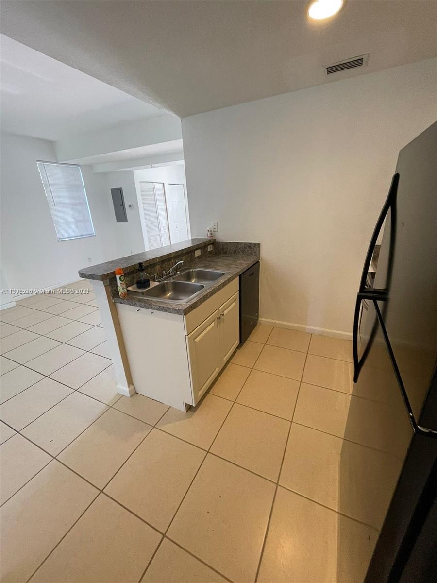 Riviera Beach Riviera Beach, FL 33404 - Photo 6 of 20 a kitchen with granite countertop a stove a sink and a refrigerator