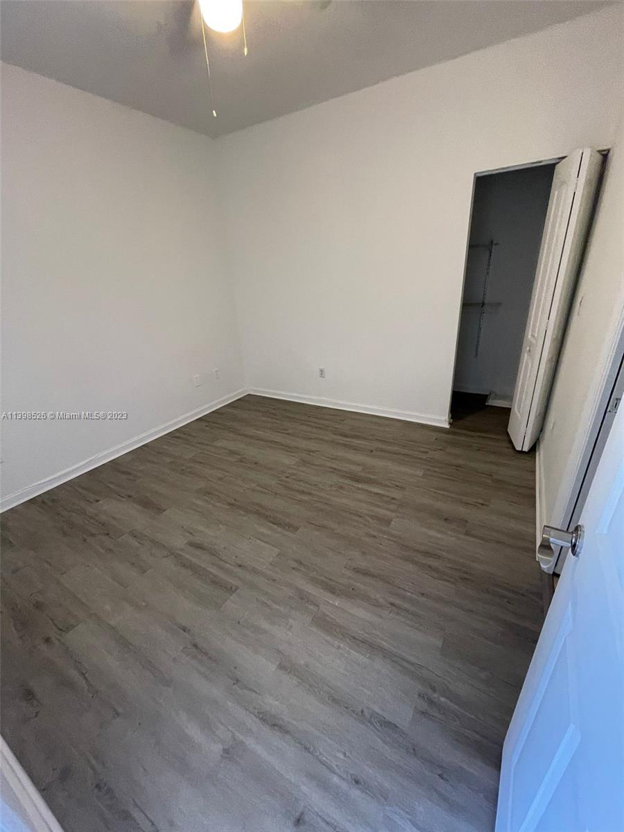 Riviera Beach Riviera Beach, FL 33404 - Photo 9 of 20 a view of an empty room with wooden floor and a window