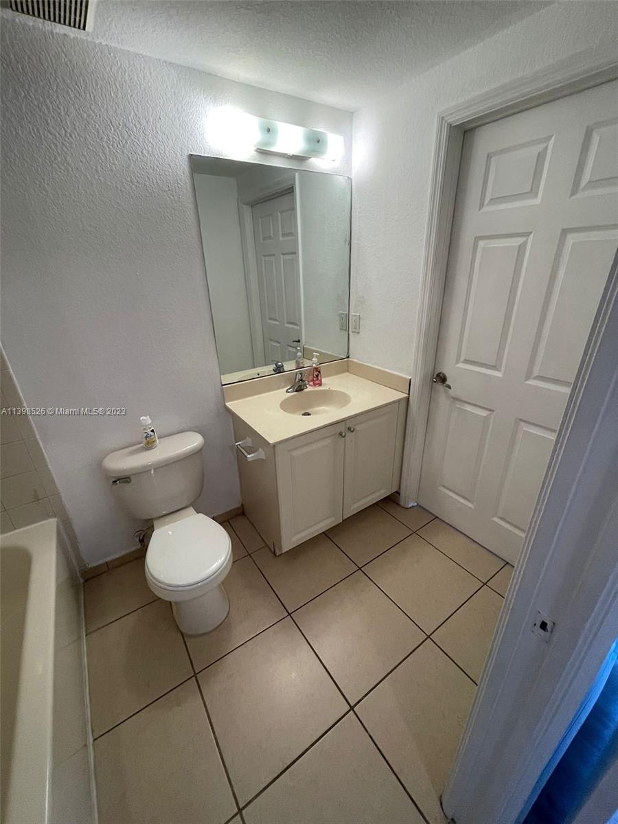 Riviera Beach Riviera Beach, FL 33404 - Photo 10 of 20 a bathroom with a sink a toilet and a mirror