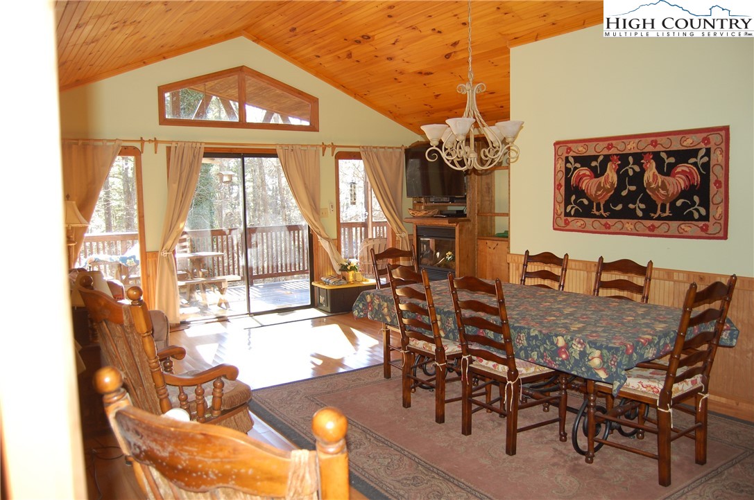 72 Robin Circle Newland, NC 28657 - Photo 6 of 24 a view of a dining room with furniture a chandelier and wooden floor
