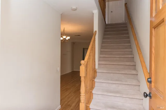 a view of entryway with wooden floor and stairs