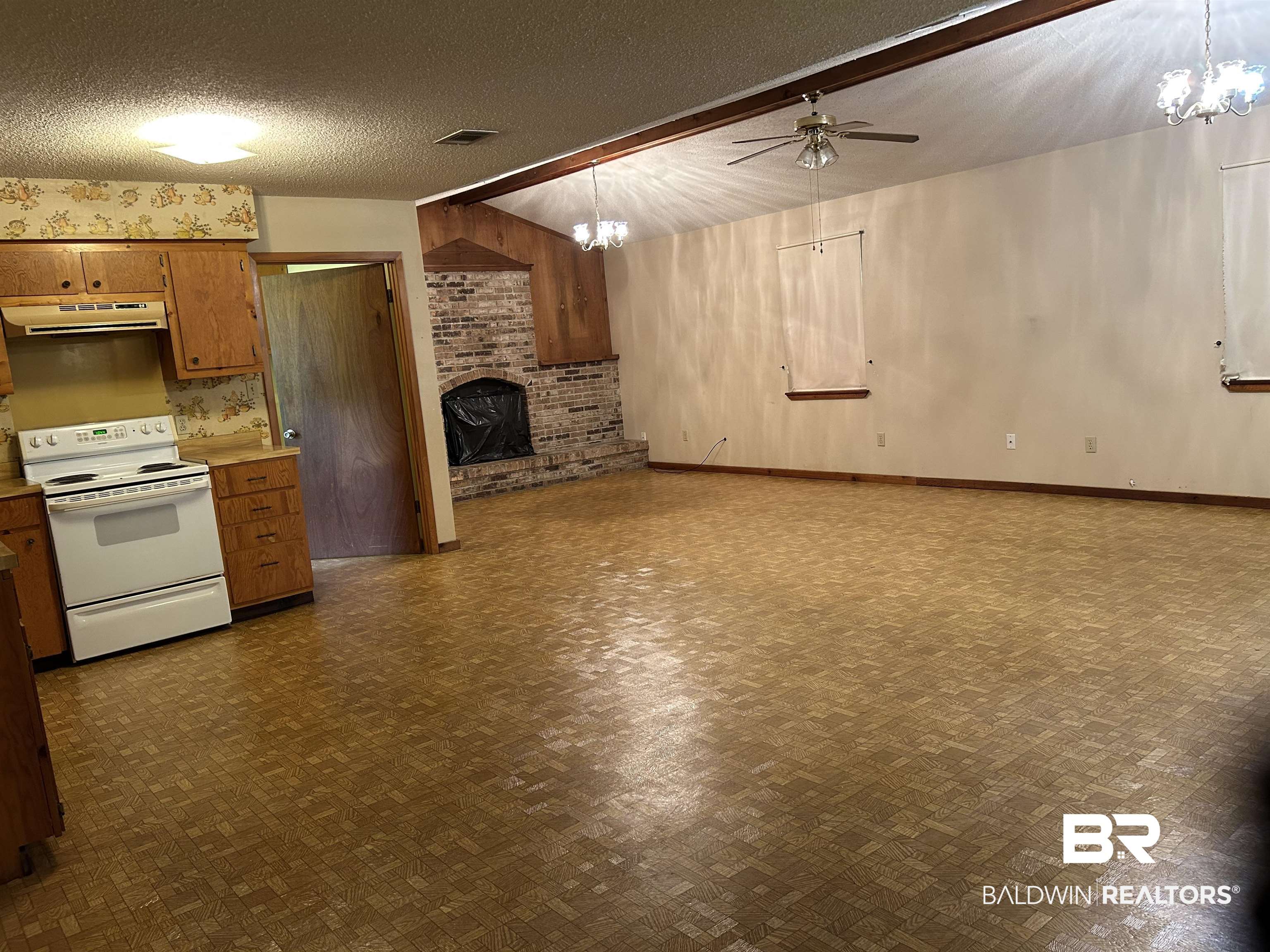1350 A Schillinger Road South Mobile, AL 36695 - Photo 18 of 18 Kitchen with white electric range, under cabinet range hood, a brick fireplace, a ceiling fan, and open floor plan
