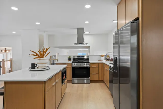 a kitchen with stainless steel appliances granite countertop a sink and a stove