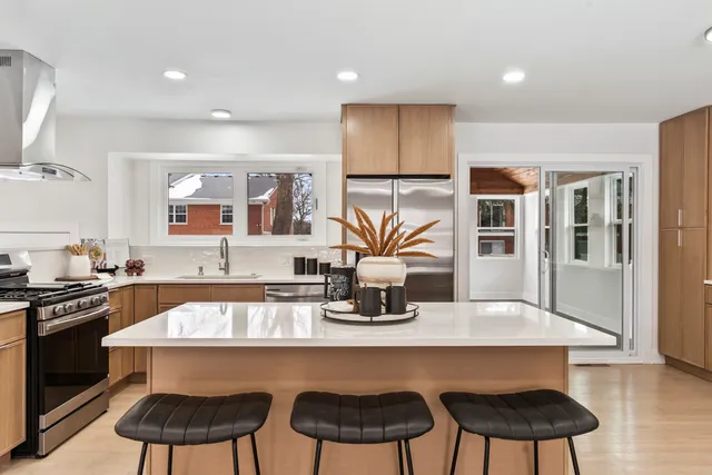 a kitchen with a table chairs stove and cabinets