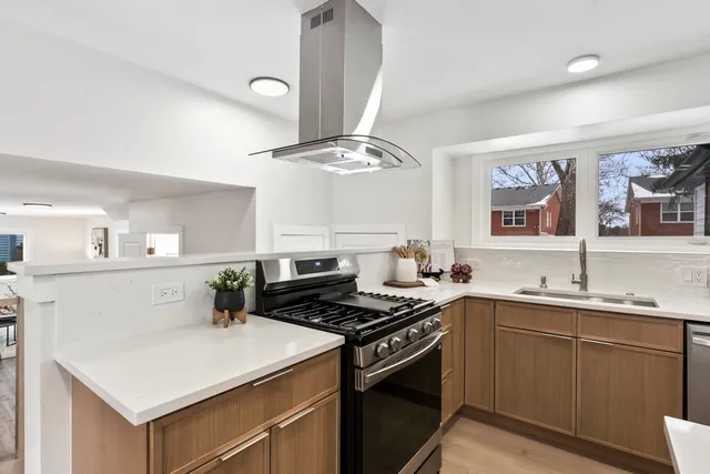 a kitchen with a sink a stove and cabinets
