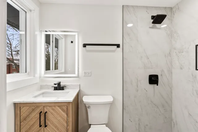a bathroom with a sink toilet and shower