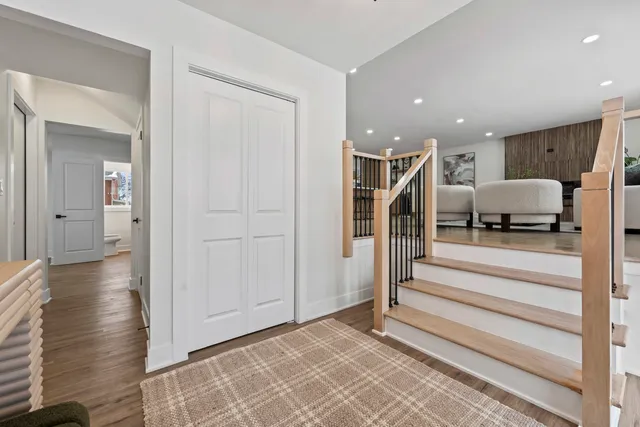 a view of entryway with wooden floor and stairs