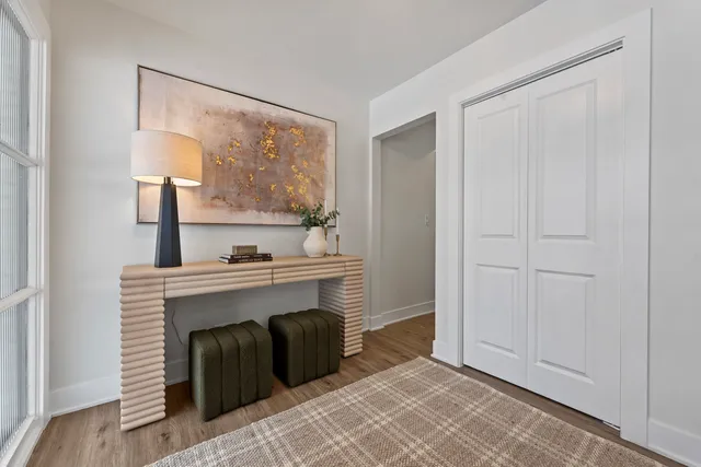 a view of an empty room with a fireplace and a window