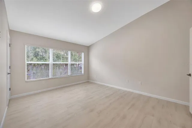 a spacious bathroom with a double vanity sink a mirror and a shower