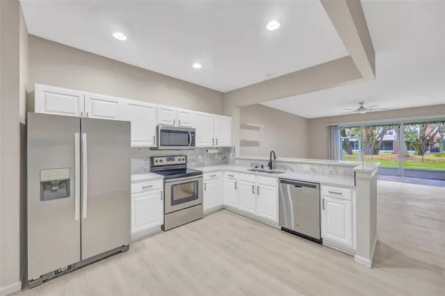 a kitchen with stainless steel appliances granite countertop a stove and a refrigerator