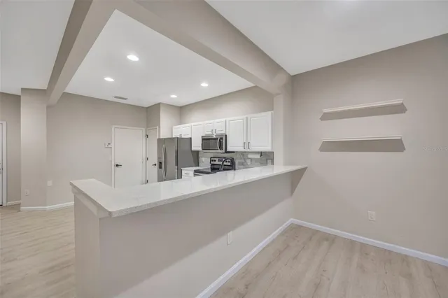 a large white kitchen with a sink