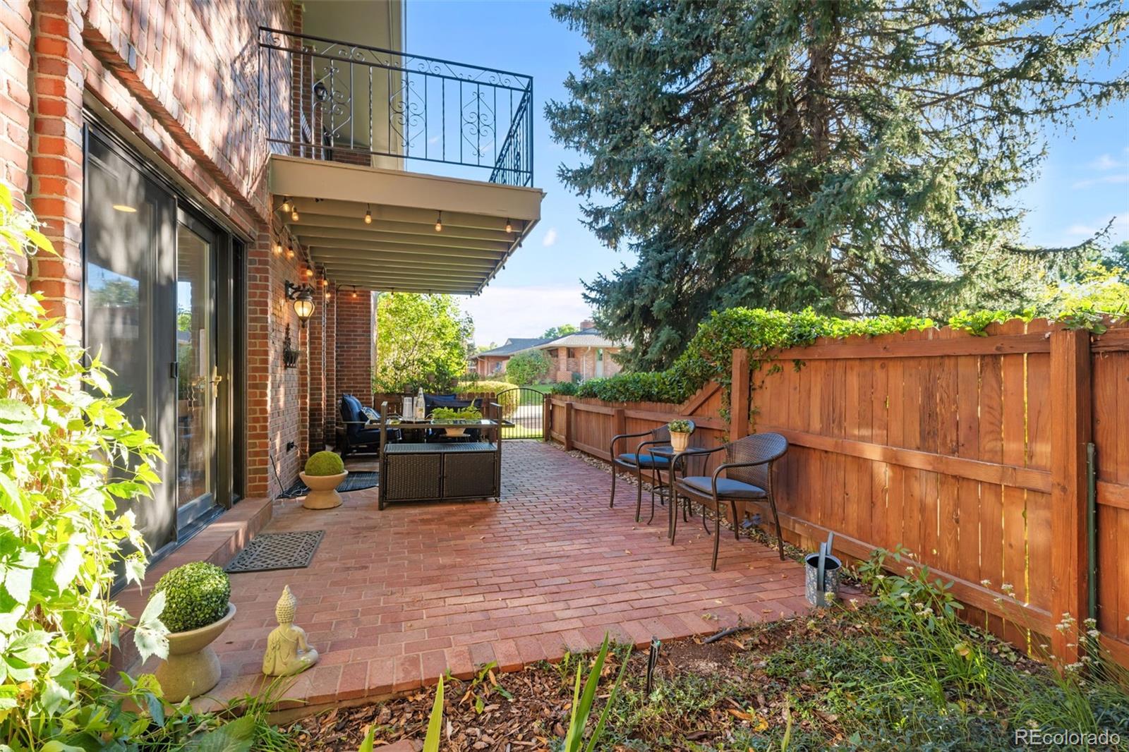 3436 South Race Street Englewood, CO 80113 - Photo 13 of 49 a view of a patio with table and chairs potted plants with wooden fence