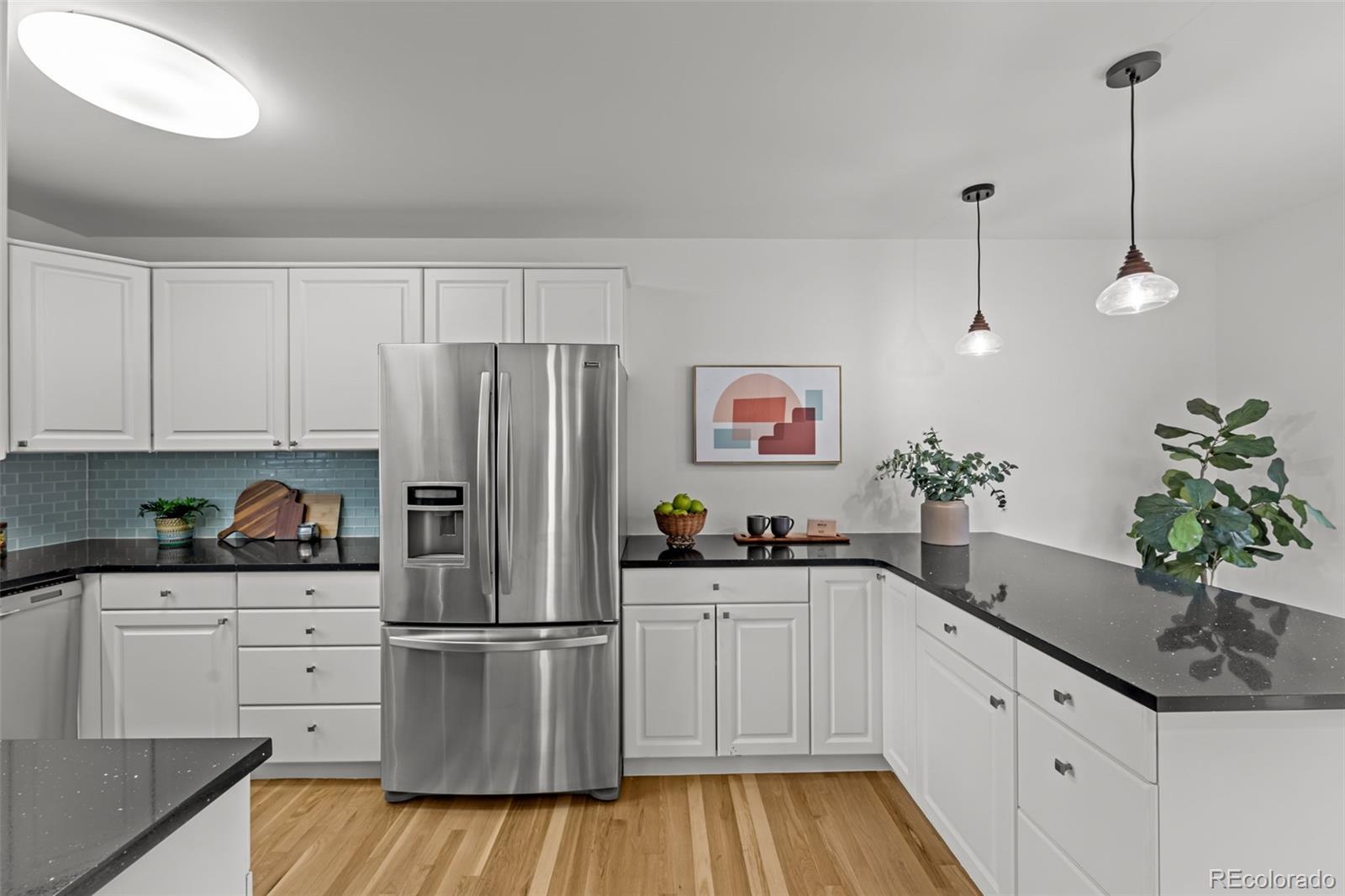 3436 South Race Street Englewood, CO 80113 - Photo 15 of 49 a kitchen with white cabinets and center island