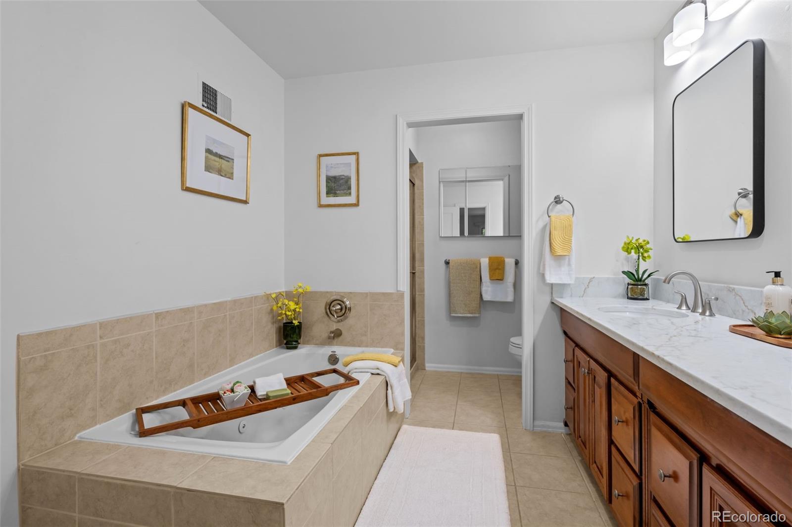 3436 South Race Street Englewood, CO 80113 - Photo 30 of 49 a bedroom with a bed and wooden floor