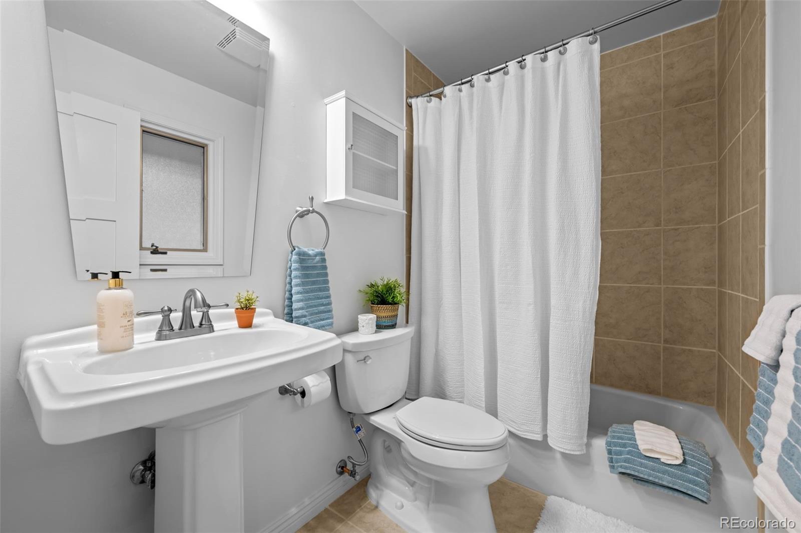 3436 South Race Street Englewood, CO 80113 - Photo 33 of 49 a bathroom with a sink toilet and shower