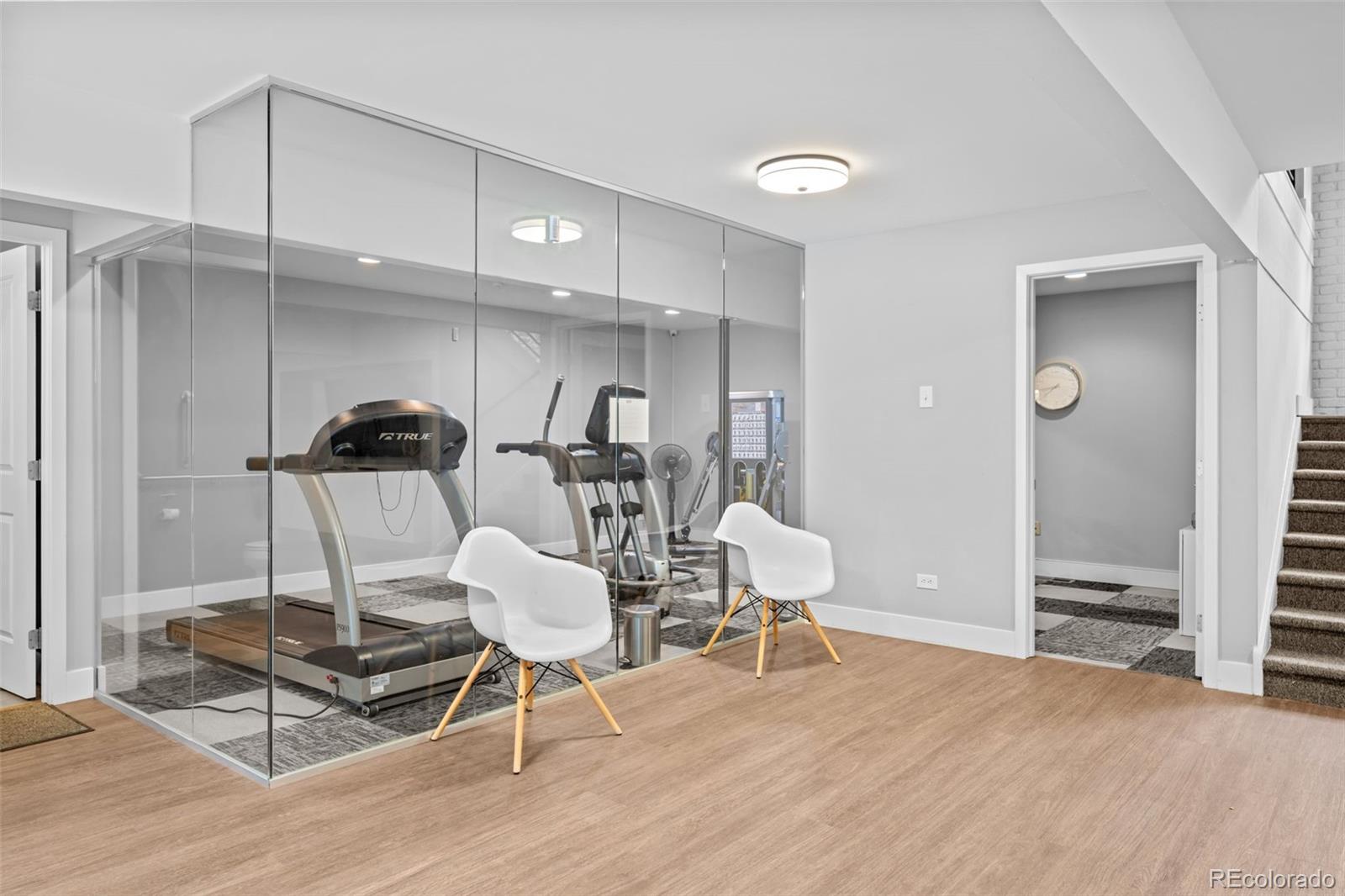 3436 South Race Street Englewood, CO 80113 - Photo 48 of 49 a living room with furniture a rug and white walls