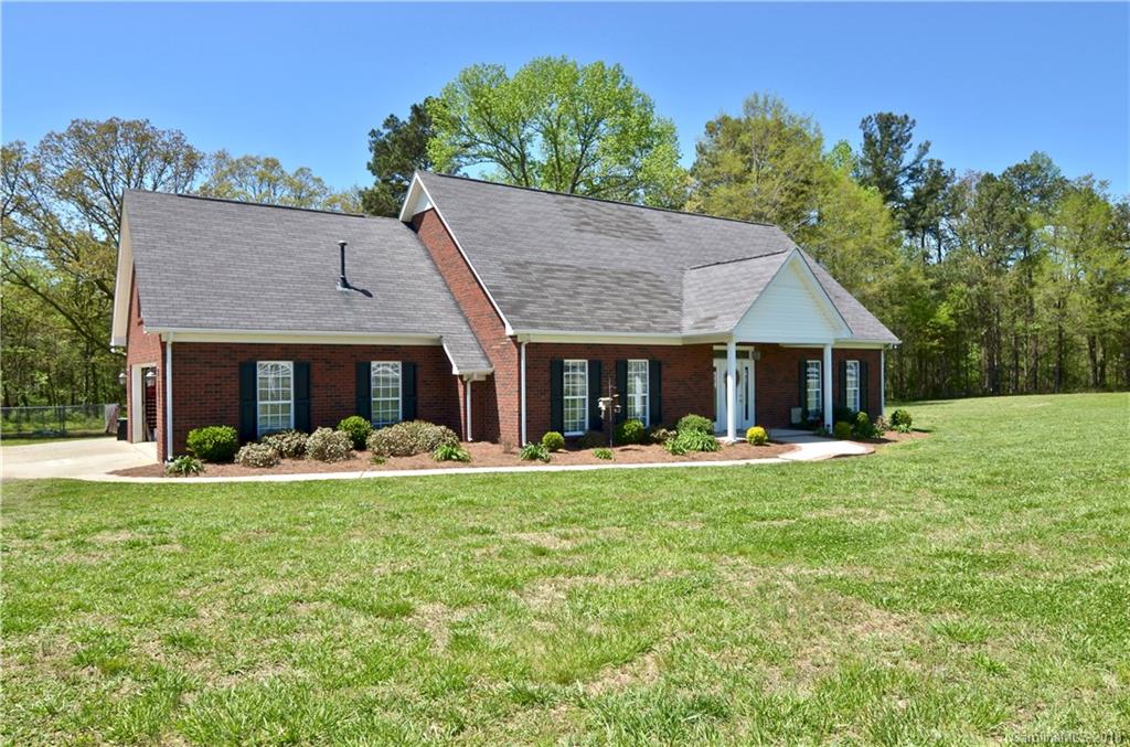 5208 Austin Road Monroe, NC 28112 - Photo 1 of 36 a front view of a house with a yard table and chairs
