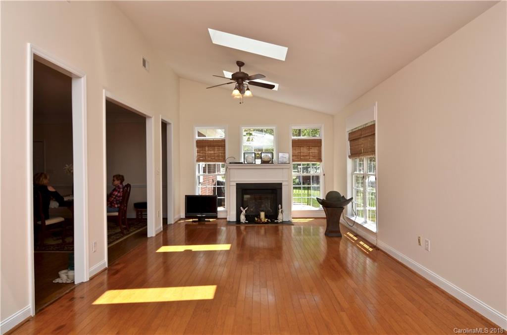 5208 Austin Road Monroe, NC 28112 - Photo 11 of 36 a view of a livingroom with a fireplace a fireplace and wooden floor