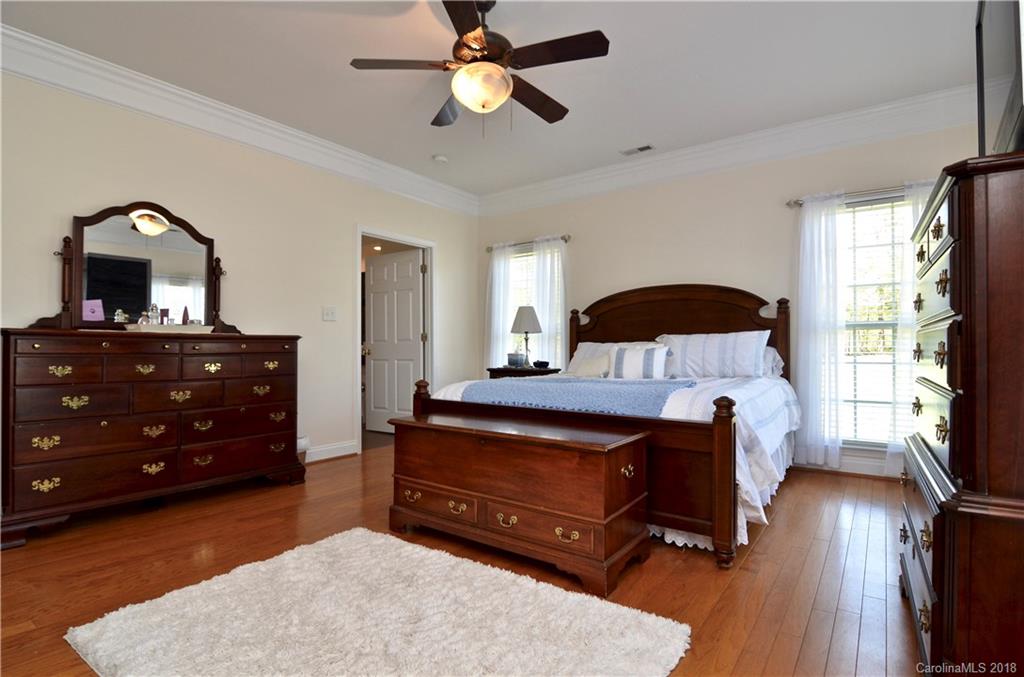 5208 Austin Road Monroe, NC 28112 - Photo 13 of 36 a bedroom with a bed and a dresser