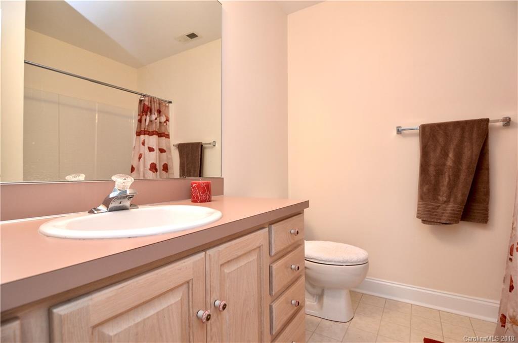 5208 Austin Road Monroe, NC 28112 - Photo 21 of 36 a bathroom with a sink a toilet and mirror