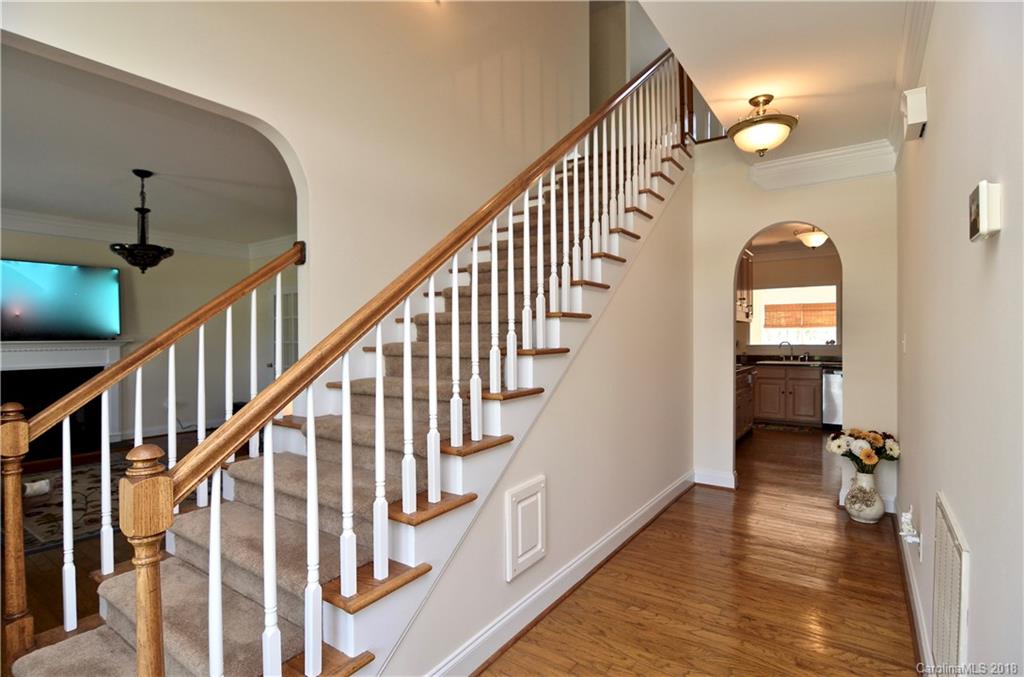 5208 Austin Road Monroe, NC 28112 - Photo 4 of 36 a view of staircase with wooden floor and fan