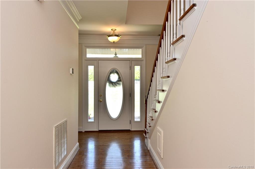 5208 Austin Road Monroe, NC 28112 - Photo 5 of 36 a view of a livingroom with wooden floor and staircase