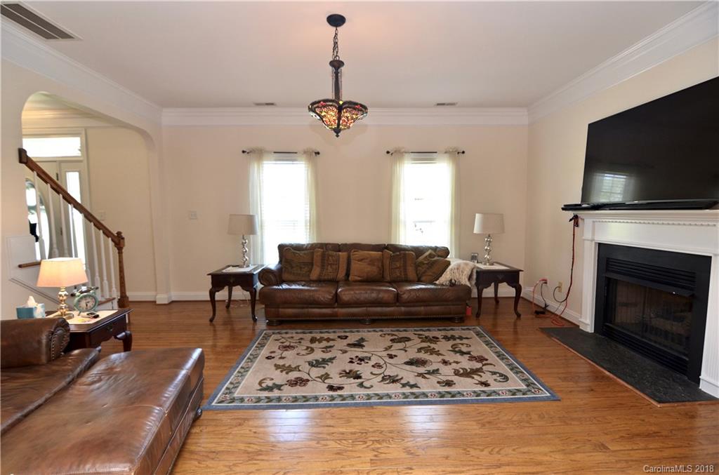 5208 Austin Road Monroe, NC 28112 - Photo 6 of 36 a living room with furniture flat screen tv and a fireplace