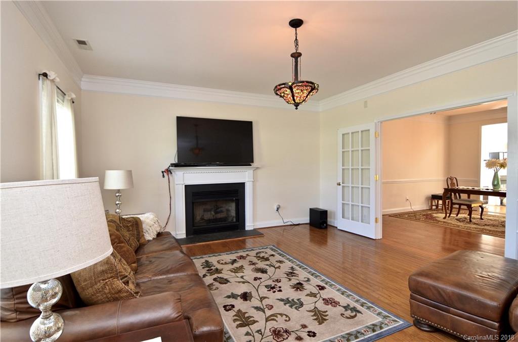5208 Austin Road Monroe, NC 28112 - Photo 7 of 36 a living room with furniture and a fireplace