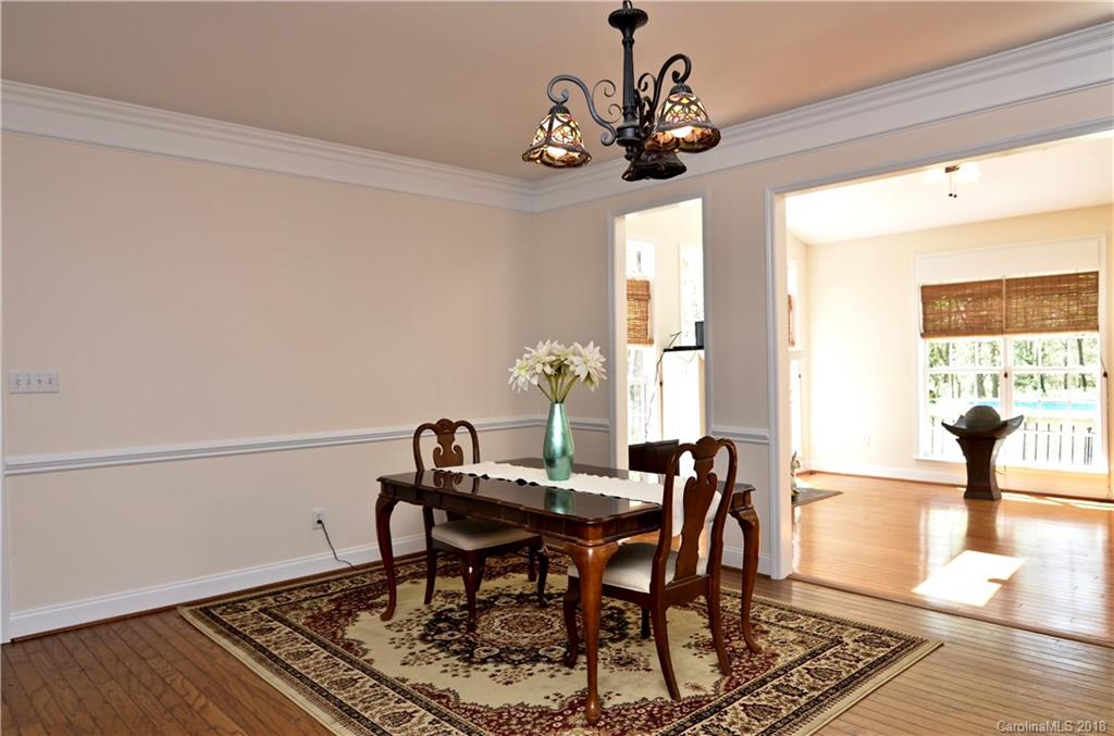 5208 Austin Road Monroe, NC 28112 - Photo 8 of 36 a view of a dining room with furniture and wooden floor