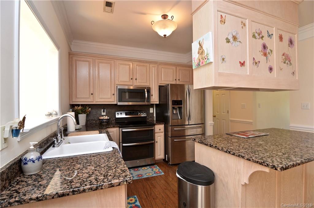 5208 Austin Road Monroe, NC 28112 - Photo 9 of 36 a kitchen with stainless steel appliances granite countertop a refrigerator stove and sink