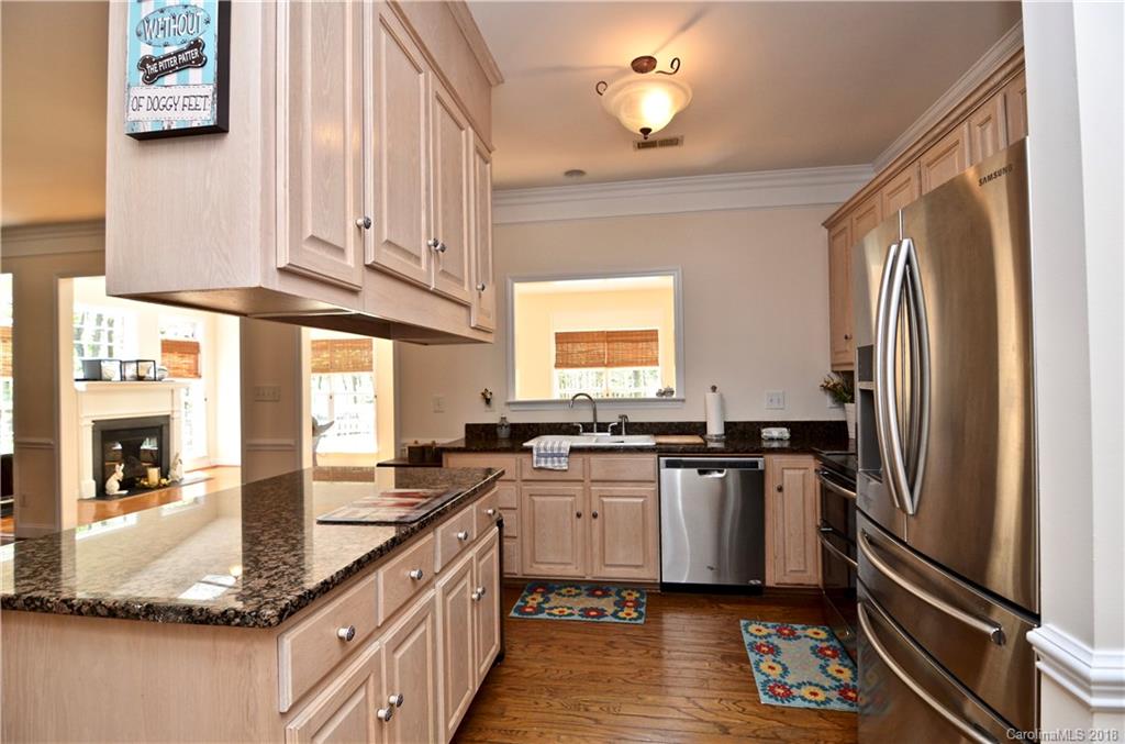 5208 Austin Road Monroe, NC 28112 - Photo 10 of 36 a kitchen with stainless steel appliances granite countertop a sink stove and refrigerator