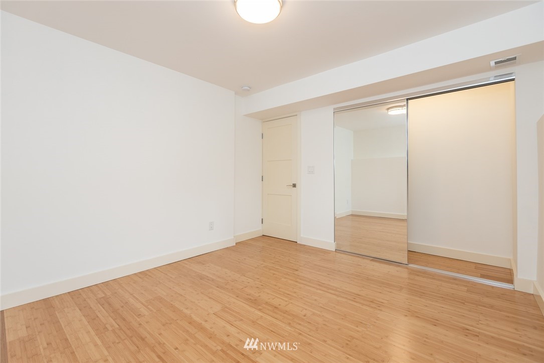 1001 North 35th Street Renton, WA 98056 - Photo 22 of 32 an empty room with wooden floor and windows