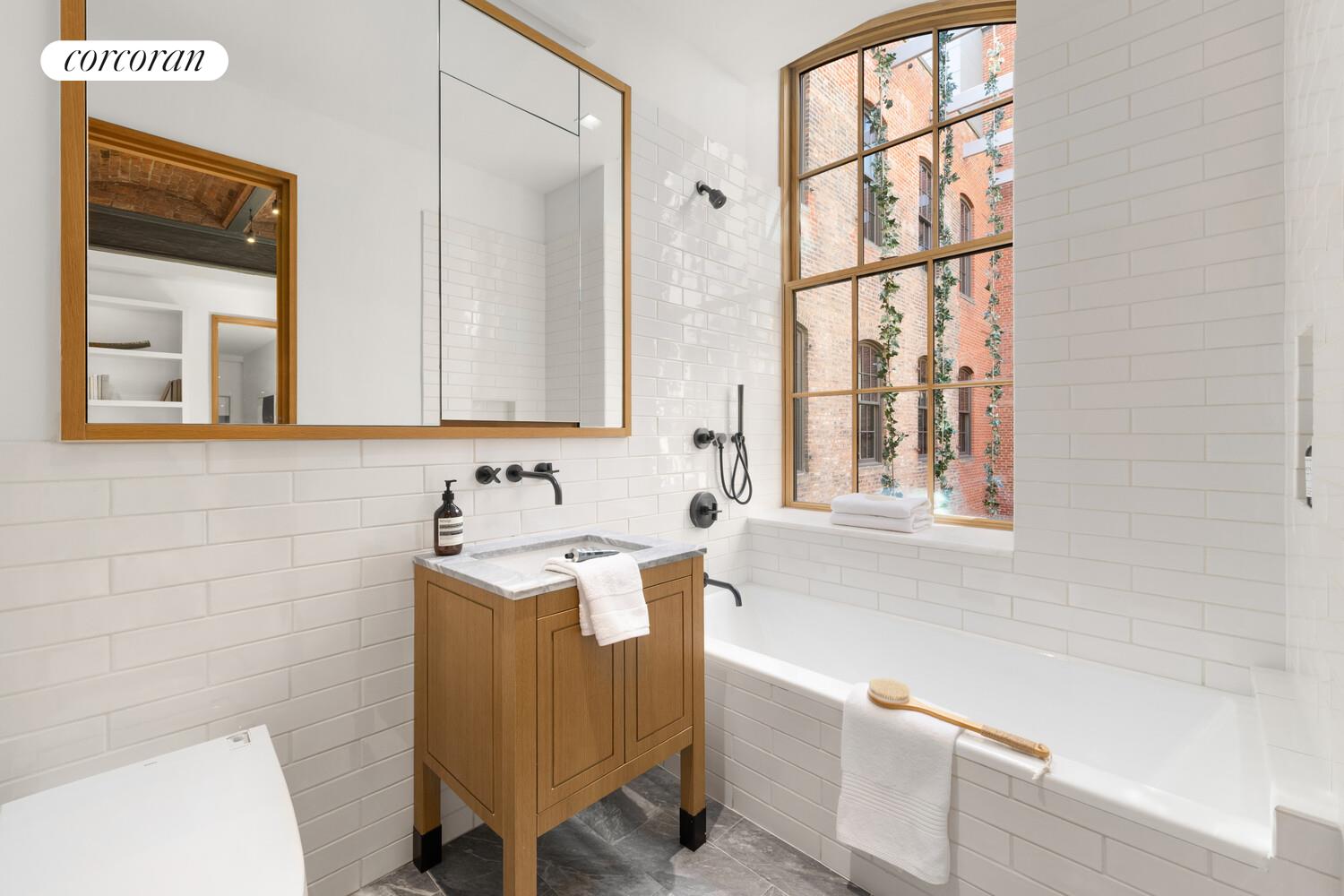 36 Bleecker Street, Unit 5A Manhattan, NY 10012 - Photo 11 of 39 a bathroom with a sink and a bathtub