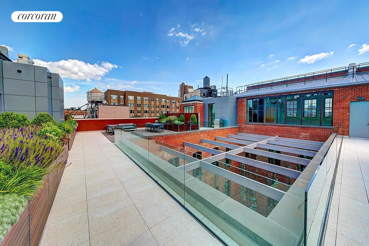 36 Bleecker Street, Unit 5A Manhattan, NY 10012 - Photo 18 of 39 a wooden deck with sunset view